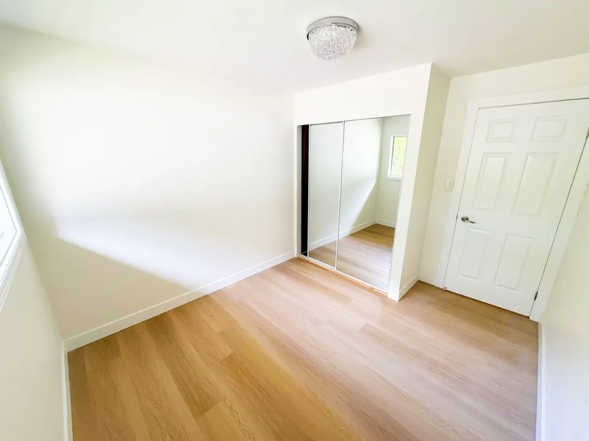 Renovated bedroom with new flooring and fresh paint