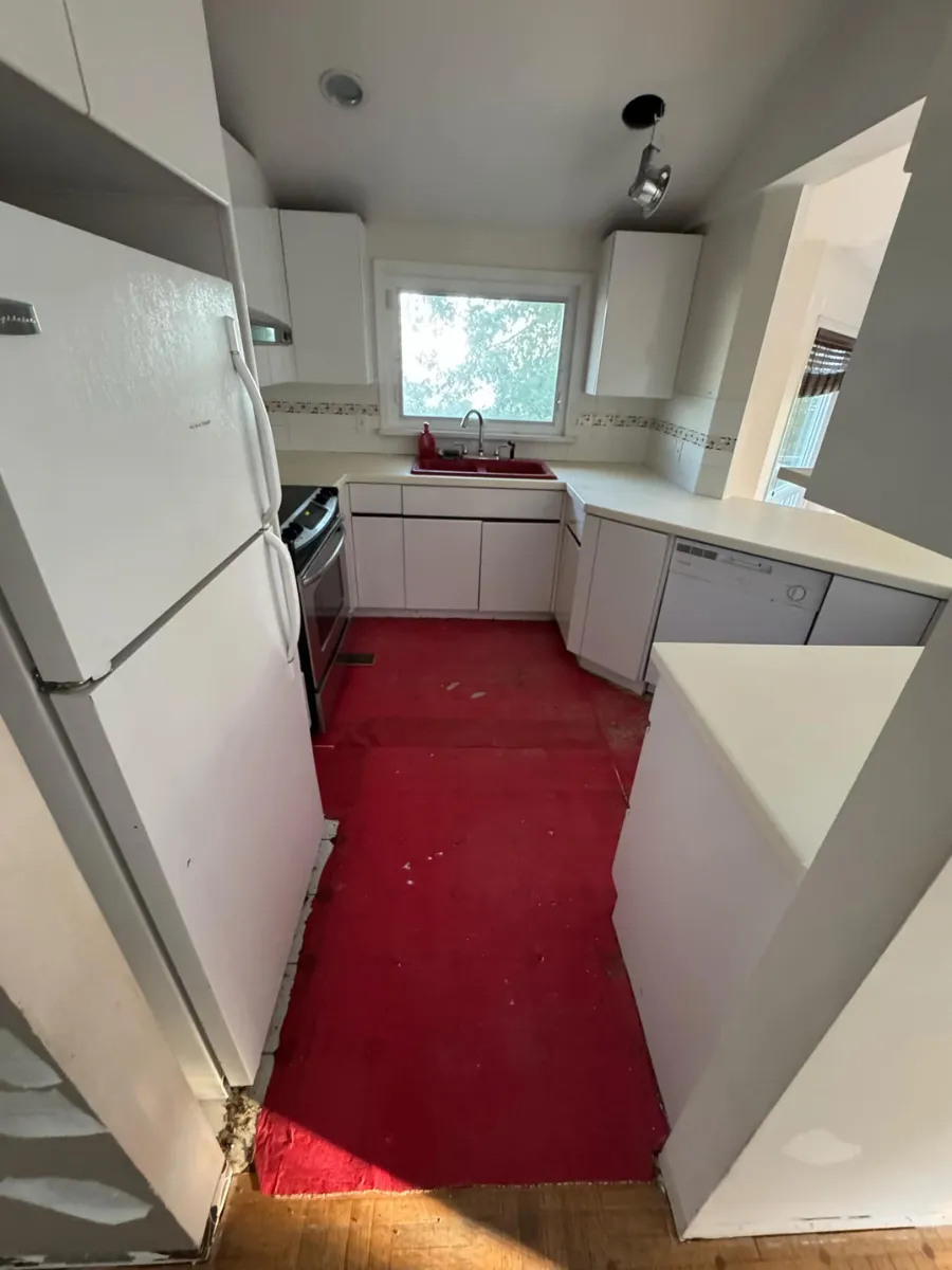 Old kitchen flooring and sink area before remodel