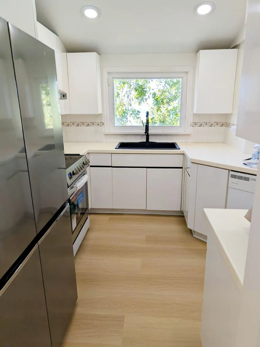 New flooring and a modern sink installed in the kitchen