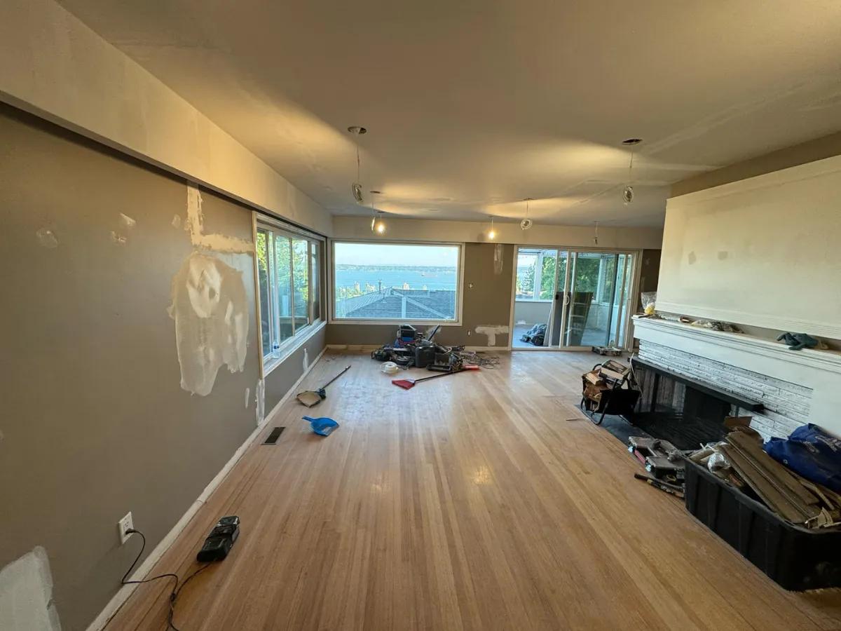 Living room before renovation, showing outdated flooring and walls